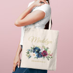 Elegant Blush and Burgundy Floral Monogram Name Tote Bag<br><div class="desc">Elegant custom tote bag features a beautiful watercolor floral arrangement in navy blue, burgundy, merlot, and blush pink with greenery. Personalize the gold coloured text with a first name in calligraphy script with bridal party title or other text. Makes a unique gift for your bridesmaids and other members of your...</div>