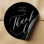Elegant calligraphy wedding thank you favour black classic round sticker<br><div class="desc">Elegant simple minimal black and white wedding favour thank you sticker featuring a classy stylish chic trendy calligraphy script.                      Easy to personalize with your details! Suitable for formal black tie neutral weddings.                 Please note that the background and text colours can be changed to match your wedding colour scheme.</div>