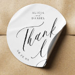 Elegant calligraphy wedding thank you favour classic round sticker<br><div class="desc">Elegant simple minimal black and white wedding favour thank you sticker featuring a classy stylish chic trendy calligraphy script.                      Easy to personalize with your details! Suitable for formal black tie neutral weddings.                 Please note that the background and text colours can be changed to match your wedding colour scheme.</div>