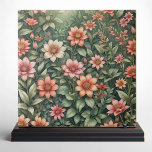 Elegant Coral and Peach Garden Blooming Flowers Tile<br><div class="desc">This beautiful ceramic tile showcases an array of vibrant flowers in shades of coral, peach, and soft pink, set against a lush backdrop of verdant green leaves. Each flower is meticulously detailed, with delicate petals and intricate centres that capture the essence of a blooming garden. The harmonious blend of colours...</div>