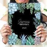 Elegant Floral Watercolor Succulent Custom Name Planner<br><div class="desc">This elegant design showcases a watercolor frame of succulents in soft green, blue, and blush hues, set against a sleek black background. The personalized name and year create a unique and refined touch, making it perfect for students, professionals, or plant enthusiasts. Ideal for organizing daily tasks, journalling, or planning with...</div>