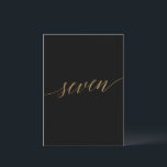 Elegant Gold Black Calligraphy Table Number Seven<br><div class="desc">This elegant gold and black calligraphy table number seven is perfect for a simple wedding. The neutral design features a minimalist card decorated with romantic and whimsical faux gold foil typography. The card prints on the front and back (double-sided). Other table numbers in the collection are sold separately. Please Note:...</div>