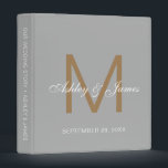 Elegant Gold Monogram Calligraphy Grey Wedding Binder<br><div class="desc">Chic wedding album or planner with your stylish monogram initial in gold and your names in white elegant handwritten script calligraphy on a silver grey background. Simply add your names, monogram and wedding date. A beautiful wedding keepsake gift album for all your wedding photos and memories. Exclusively designed for you...</div>