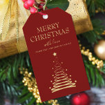 Elegant Gold Red Christmas Tree Custom Gift Tags<br><div class="desc">Add a special touch to your holiday gift-giving this season with our Elegant Gold and Red Christmas Tree Custom Gift Tags. These stunning gift tags feature a beautifully designed gold holiday tree on a bold red background, with the words "Merry Christmas" written in elegant typography font. But that's not all...</div>