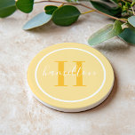 Elegant Golden Yellow Custom Monogram Initial Coaster<br><div class="desc">Elegant round personalized beverage drink coaster design features a classic custom serif monogram initial in a sunny golden marigold yellow colour with your last name in modern white calligraphy script against a light yellow coloured background. A simple white circle frames the design. Colour scheme can be customized to coordinate perfectly...</div>