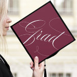 Elegant Grad Calligraphy Script Burgundy Graduation Cap Topper<br><div class="desc">Chic and stylish graduation cap topper featuring "Grad" in a modern calligraphy script against a maroon background. Change the background colour and add text with the Customize tool.</div>