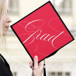 Elegant Grad Calligraphy Script Red Graduation Cap Topper<br><div class="desc">Chic and stylish graduation cap topper featuring "Grad" in a modern calligraphy script against a red background. Change the background colour and add text with the Customize tool.</div>