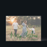 Elegant Green Script Photo Modern Christmas Holiday Card<br><div class="desc">Modern photo Christmas card featuring a simple and minimal design with the greeting "Merry Christmas" in an elegant green script along with your family name. The template includes a sheer overlay to help the text stand out on the front photo and may be removed in the design editing tool. The...</div>