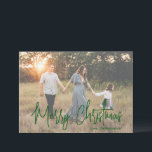 Elegant Green Script Photo Modern Christmas Holiday Card<br><div class="desc">Modern photo Christmas card featuring a simple and minimal design with the greeting "Merry Christmas" in an elegant green script along with your family name. The template includes a sheer overlay to help the text stand out on the front photo and may be removed in the design editing tool. The...</div>