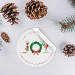 Elegant joy Christmas wreath family address  Classic Round Sticker<br><div class="desc">Simple elegant family or business Christmas holiday sticker featuring JOY floral typography script with retro traditional fir branches wreath,  holly berries,  and a red bow.              Personalize it with your name and text!</div>
