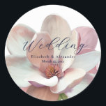 Elegant Magnolia Pink and White Wedding Classic Round Sticker<br><div class="desc">Elegant Magnolia Pink and White Wedding Sticker for your wedding invitation mailings. Designed with a soft pink and white magnolia flower on a white background. The text includes: Wedding, the Bride & Groom's First Names, and Wedding Date. To personalize, simply replace the sample text with your own. Be sure to...</div>