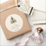 Elegant Merry Christmas Pine Tree Bow Family Classic Round Sticker<br><div class="desc">Add a festive touch to your gifts with these elegant "Merry Christmas" stickers! Featuring gold script,  a pine tree bow,  and your custom family name,  they're perfect for personalizing your holiday packages with style and warmth.</div>