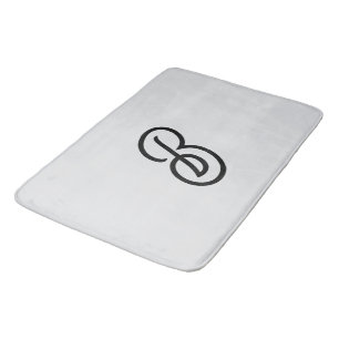 Elegant minimalist modern initial on grey bath mat