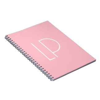 Elegant minimalist modern initial on pastel pink notebook