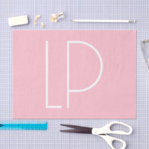 Elegant minimalist modern initial on pastel pink tissue paper