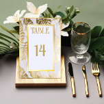 Elegant Monstera Gilded Gold Wedding Table Number<br><div class="desc">Our Tropical Wedding Table Number Card is thoughtfully crafted, showcasing an elegant white design that exudes elegance and grace. The hot tropics theme adds a touch of exotic allure, perfectly complementing your destination wedding. The monstera leaves and gilded gold accents add a luxurious and glamourous touch to the table number...</div>