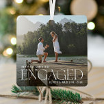 Elegant Our 1st Christmas Engaged Photo Keepsake Metal Ornament<br><div class="desc">Beautiful minimal and modern couple's photo engagement christmas ornament. Simple and modern design with a full photo template. Customize this gift with your special engagement photo, year, and name/s. The photo has an overlay at the bottom to help the elegant white typography "Engaged" stand out. Perfect keepsake ornament for couples...</div>