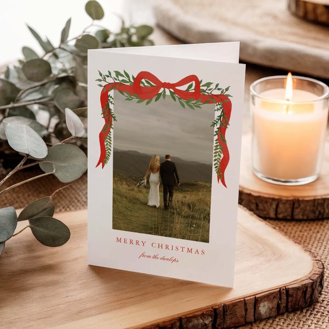 Elegant Red Bow with Greenery Photo Christmas Holiday Card (Elegant red ribbon with bow and greenery folded photo Christmas holiday cards. )