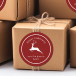 Elegant Red Merry Christmas Reindeer Custom Gift Classic Round Sticker<br><div class="desc">An elegant white reindeer leaps underneath Merry Christmas. Personalize these red holiday gift labels your family name underneath for beautiful custom presents.</div>
