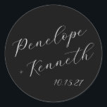 Elegant Script Calligraphy Wedding Custom Black Classic Round Sticker<br><div class="desc">Add a touch of timeless elegance to your wedding with these custom round stickers featuring beautiful script calligraphy. The sleek black background creates a striking contrast with the crisp white lettering, offering a chic and sophisticated look. Perfect for sealing envelopes, decorating favours, or adding a personalized touch to your wedding...</div>