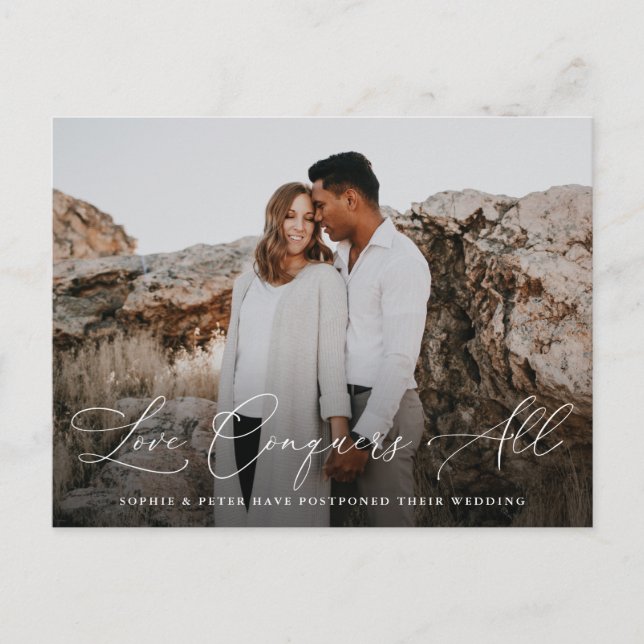 Elegant Script Love Conquers All Postponement Announcement Postcard (Front)