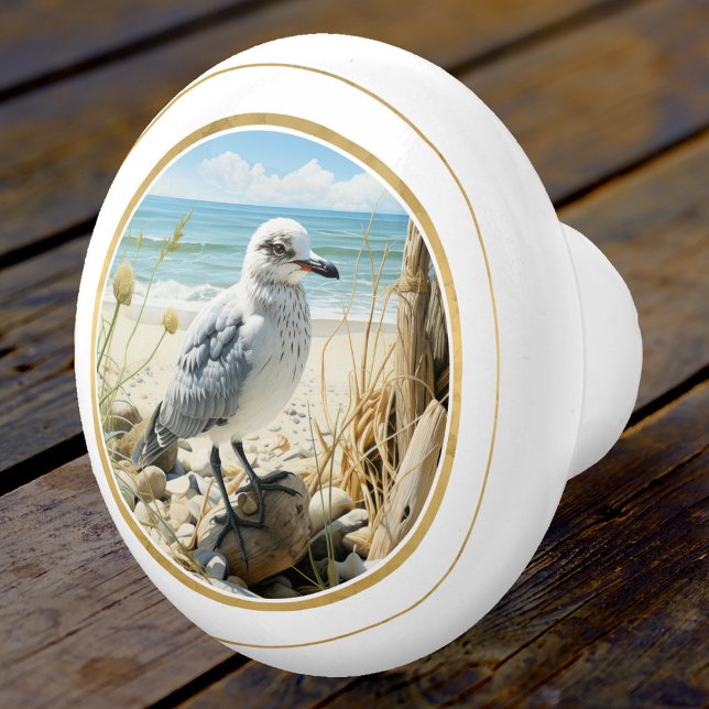 Elegant Seagull Beach Coastal  Ceramic Knob (An elegant ceramic door knob featuring a young seagull at the beach with a gold stylized lining)