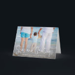 Elegant Seas and Greetings Beach Photo Christmas Holiday Card<br><div class="desc">Send out holiday cheer with this nautical themed folded Christmas card featuring a simple design with the words "Seas and Greetings" in an elegant thin white script, along with your message over your favourite horizontal beach vacation photo. Add your personal message to the inside or delete the text if you...</div>