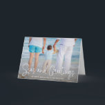 Elegant Seas and Greetings Beach Photo Christmas Holiday Card<br><div class="desc">Send out holiday cheer with this nautical themed folded Christmas card featuring a simple design with the words "Seas and Greetings" in an elegant thin white script, along with your message over your favourite horizontal beach vacation photo. Add your personal message to the inside or delete the text if you...</div>