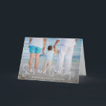 Elegant Seas and Greetings Beach Photo Christmas Holiday Card<br><div class="desc">Send out holiday cheer with this nautical themed folded Christmas card featuring a simple design with the words "Seas and Greetings" in an elegant thin white script, along with your message over your favourite horizontal beach vacation photo. Add your personal message to the inside or delete the text if you...</div>