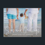 Elegant Seas and Greetings Beach Photo Christmas Holiday Postcard<br><div class="desc">Send out holiday cheer with this nautical themed Christmas postcard featuring a simple design with the words "Seas and Greetings" in an elegant thin white script,  along with your message over your favourite horizontal beach vacation photo.  The backside has your personal message and your return address for easy mailing.</div>