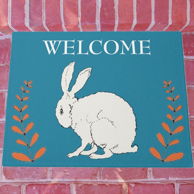 Elegant Sitting White Rabbit Orange Plants on Blue Doormat (White sitting rabbit with tall orange plants on dark blue Welcome outdoor mat.)