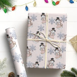 Elegant Snowman & Glitter Snowflake Christmas Wrapping Paper<br><div class="desc">Wrap your gifts in festive charm with this elegant Christmas wrapping paper. This pattern features a adorable snowmen dressed in top hat and pink coat, holding a festive ornament, surrounded by glittery silver snowflakes on a soft pale pink background. Perfect for adding a touch of sophistication and warmth to your...</div>