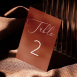 Elegant Terracotta Brick Minimalist Fall Wedding Table Number<br><div class="desc">This elegant table number card features a burnt sienna background, with delicate white script and clean typography for a warm, refined look. The warm terracotta brick colour adds a cozy, autumn feel to your decor, while soft rust clay tone makes it perfect for fall weddings, boho themes, or rustic events....</div>