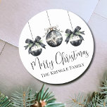 Elegant Watercolor Christmas Party Classic Round Sticker<br><div class="desc">Add a festive and elegant touch to your holiday cards, party invitations, or favour gifts with this beautifully designed Christmas sticker. Featuring three delicate watercolor ornaments in soft black and white shades, accented with evergreen greenery and bow details, this sticker offers a simple yet sophisticated look. "Merry Christmas" is displayed...</div>