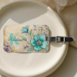 Elegant Watercolor Teal Bloom with Golden Swirls Luggage Tag<br><div class="desc">Elevate your travel style with this exquisite watercolor floral luggage tag. A vibrant turquoise blossom takes centre stage, framed by delicate purple accents and swirling gold flourishes that add a touch of elegance. Soft script in the background enhances the sophisticated charm, creating a design that feels both artistic and timeless....</div>