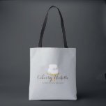 Elegant White Cake with Florals Bakery Tote Bag<br><div class="desc">An elegant white tiered cake decorated with flowers sits atop a faux gold cake stand for a beautiful aesthetic on this bakery-themed personalized tote bag. Perfect for bakers,  catering companies,  cake decorators,  or for personal use. Design © 1201AM Design Studio</div>