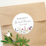 Elegant Wildflower Meadow Bridal Shower Classic Round Sticker<br><div class="desc">Elegant floral bridal shower stickers featuring a bottom border of watercolor wildflowers and foliage in shades of pink, yellow, purple, blue, and green on a white background. Personalize the wildflower bridal shower stickers with the bride-to-be's name and the date. The personalized wildflower stickers are perfect for spring and summer bridal...</div>