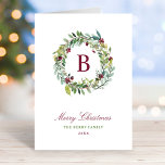 Elegant Winter Greenery Burgundy Monogram Wreath Holiday Card<br><div class="desc">This elegant and minimal Christmas folded holiday card features a floral greenery watercolor wreath design framing a custom burgundy / wine red monogram initial along with stylish burgundy red, green, and dark gray text that can be fully personalized with your "Merry Christmas" holiday greeting, a custom message inside the card,...</div>