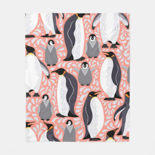 Emperor penguins and their cubs on a pink patterne fleece blanket