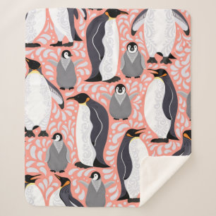 Emperor penguins and their cubs on a pink patterne sherpa blanket