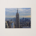 Empire State Building Jigsaw Puzzle<br><div class="desc">Dramatic photo of iconic New York City landmark,  the Empire State Building,  against a blue sky with white clouds. Photo credit: Bobby Mikul.</div>
