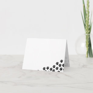 Empreintes de patte de chiot noir 