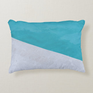 Empty gray floor beside pool accent pillow