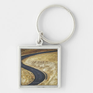 Empty winding paved road keychain