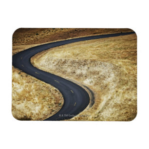 Empty winding paved road magnet