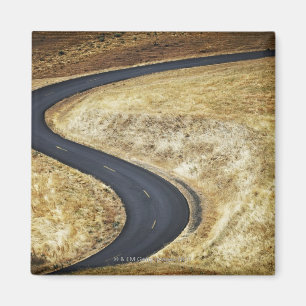 Empty winding paved road magnet