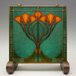 Enchanted Blossom Stained Glass Tile<br><div class="desc">Transform your living space with the Enchanted Blossom Stained Glass Ceramic Tile, a captivating piece printed by Zazzle. This flat ceramic tile, designed with no embossed features, exudes the charm of Art Nouveau with its intricate stained glass effect. The design features an elegant arrangement of orange blossoms, gracefully intertwined against...</div>