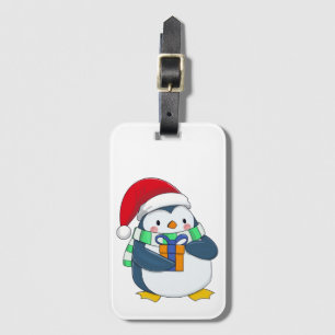 Étiquette À Bagage Penguin dans un casquette de Noël avec un cadeau