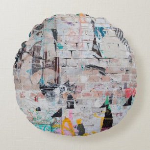 Exposed weathered brick wall with torn street post round pillow