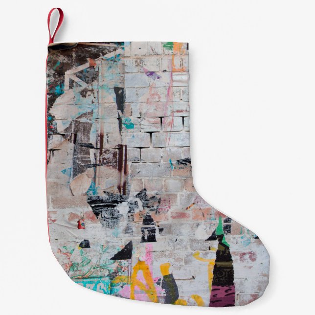 Exposed weathered brick wall with torn street post small christmas stocking (Front)